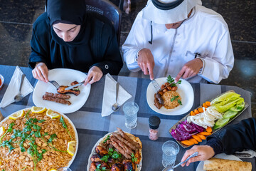 Happy arabic muslim family enjoying the food togther in ramadan