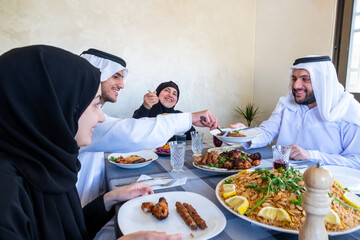 Happy arabic muslim family enjoying the food togther in ramadan