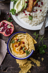 Directly above shot of Hummus or humus In bowl on table. Vegan plant based food