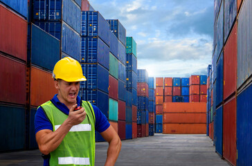 industrial worker is controlling container loading in import-export business.