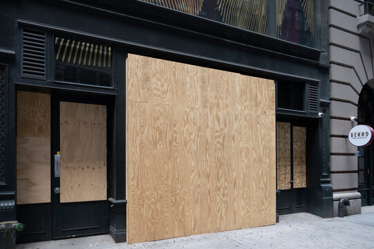New York, New York, USA - June 26, 2020: Boarded up store windows in Manhattan north of Madison Square.
