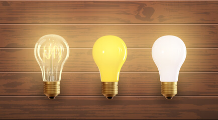Set of electric lamps, edison, tungsten, fluorescent and led. Isolated on a wood background. Incandescent lamp with bright light. Concept of business idea