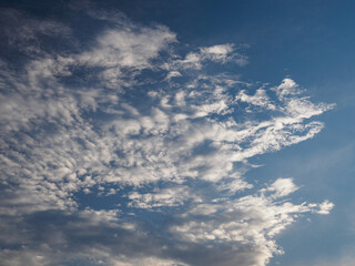 Fototapeta na wymiar White sparse clouds in a blue sky.