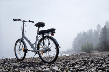 Bicycle on natural rocky beach outdoors background. Journey on bike.