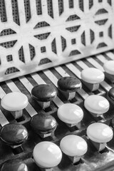 Russian musical instrument. Black and white buttons on the button accordion. Chromatic hand...