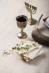 Fototapeta premium Passover, the Feast of Unleavened Bread, matzah and Kosher red wine glasses shofar (horn) with religious holy prayer book on table