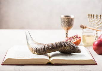 Naklejka na ściany i meble Rosh hashanah - jewish New Year holiday concept. Traditional symbols: Honey jar and fresh apples with pomegranate and shofar-horn, Prayer book. Copy space for text. View from above