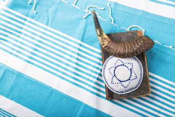 Jewish traditional objects, yarmulke, Tallit, Prayer book shofar horn on blue jewish prayer shawl. ...