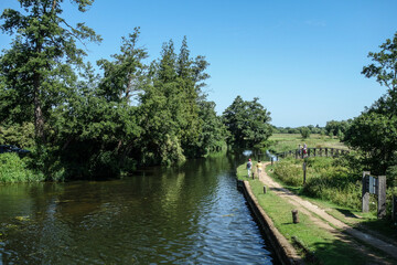 Fototapeta na wymiar Walkers beside The River Wey Near Triggs Lock Guildford Surrey