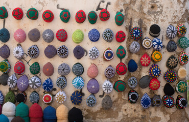 colorful hats on a wall at a market in Morocco