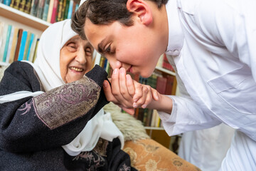 Arabic muslim son kissing his grandmother hand