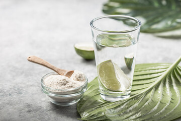 Collagen Powder and glass of water with  slice of Lime; Vitamin C . Collagen supplements may...