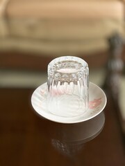 Glass cup placed in a saucer