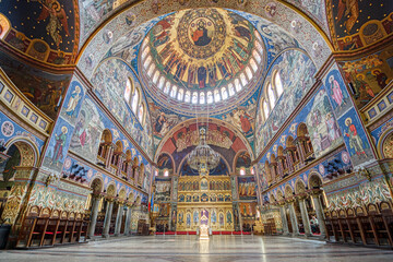 Fototapeta na wymiar SIBIU, ROMANIA - Circa 2020: big church interior. Beautiful paintings in a European church. Concept of prayer religion and faith.