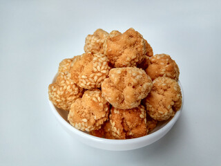 Onde-onde ceplis, or onde-onde ketawa, or tiny fried sesame balls that cracked, a popular Indonesian snack. Isolated in white background