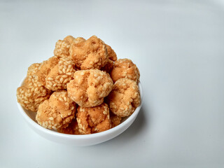 Onde-onde ceplis, or onde-onde ketawa, or tiny fried sesame balls that cracked, a popular Indonesian snack. Isolated in white background