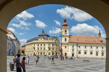 SIBIU, ROMANIA - Circa 2020: Old medieval town with cloudy blue sky. Beautiful tourist spot in eastern central Europe. Famous Big Square in Sibiu Romania