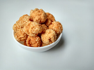 Onde-onde ceplis, or onde-onde ketawa, or tiny fried sesame balls that cracked, a popular Indonesian snack. Isolated in white background