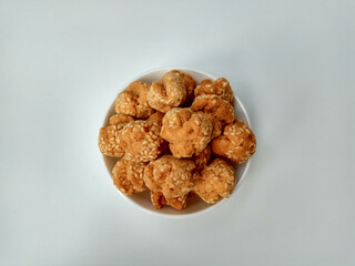 Onde-onde ceplis, or onde-onde ketawa, or tiny fried sesame balls that cracked, a popular Indonesian snack. Isolated in white background