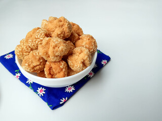Onde-onde ceplis, or onde-onde ketawa, or tiny fried sesame balls that cracked, a popular Indonesian snack. Isolated in white background