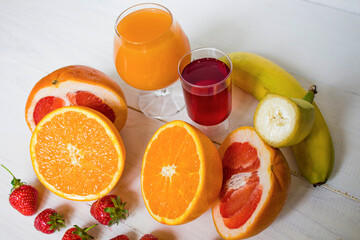 Fresh fruits. Healthy food. Mixed fruit, strawberries and banana, citruses. Studio photography of various fruits on an old wooden table. Organic healthy assorted fruits. Assortment of fresh fruit. Fre