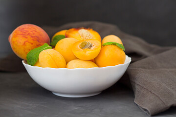 Fresh fruits. Healthy food. Mixed fruits, apricots and peaches. Studio photography of various fruits on an old wooden table. Organic healthy assorted fruits. Assortment of fresh fruits. Fruit food bac