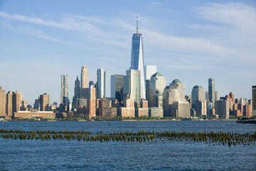 New York, NY / USA - 5/8/18: Skylline view of lower Manhattan, with remains of an old pier in the foreground