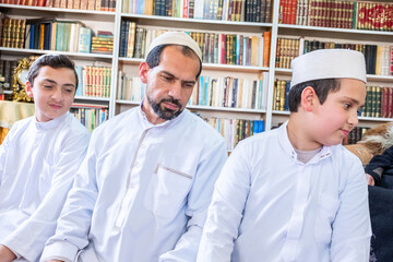 Muslim family leaning left and right to finish praying