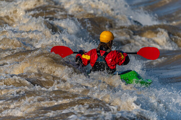 a freestyle kayaker on the river
