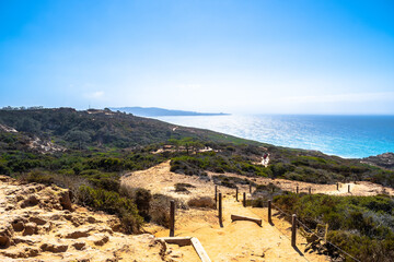 San Diego, California. Dirt path through sandstone desert land on downhill mountain climb. Hike/ Hiking trail landscape. Sunny summer day in La Jolla, Torrey Pines with view of cliffs and the Ocean.