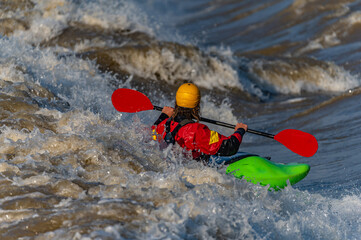 a freestyle kayaker on the river