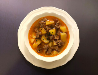 Classic gulash or goulash soup. Beef meat and potatoes in which is cut into cubes, with paprika,...