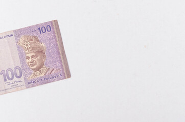 Malaysia Currency (MYR) Ringgit Malaysia bank note. Close up on money showing the first of Malaysian King on Rm100 notes.