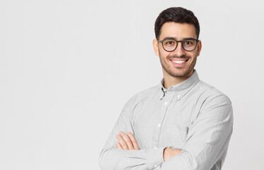 Banner of handsome businessman wearing gray shirt and glasses, holding arms crossed, isolated with...