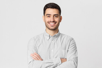 Smiling businessman in gray shirt isolated on studio background