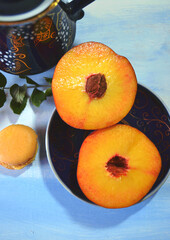 Food still life with peach slices, peach macaron, ash berries (Sorbus in Latin) and indigo blue jar...