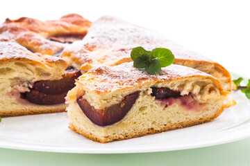 sweet baked homemade plum cake with icing sugar