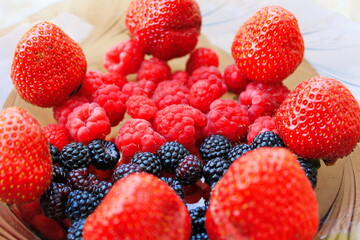 summer plate with fruits from strawberries raspberries and rare black raspberries