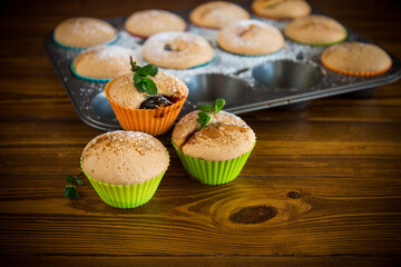 sweet baked muffins with fruit filling in icing sugar
