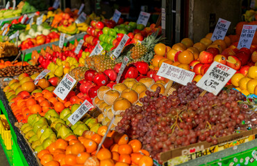 Fresh fruits like apples, pears, grapes and oranges for sale at a stall at Pike Place Market in Seattle, Washington