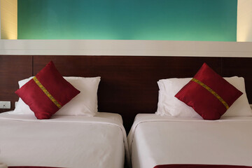 twin bed in hotel room with Red pillows, hotel interior concept