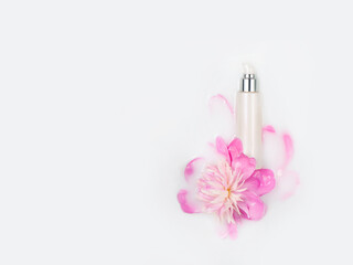 Jar of cream and peony flower in a bath with milk. Gentle care. Conceptual photography, the best cosmetic tool for body and face care. Natural cosmetics, mock up.