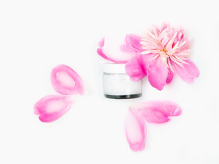 Obraz na płótnie Canvas Cream and peony flower in a bath with milk. Conceptual photo: the best cosmetic tool for body and face care. Gentle care. Natural cosmetics, mock up.