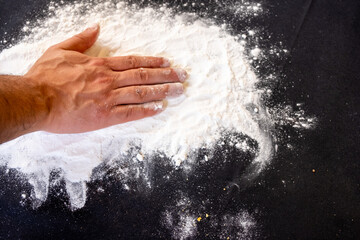 Muslim man writing eid mubarak with flour