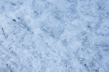 Ice texture. Beautiful winter frosty background. Cool ice patterns on the frozen surface of the water. Cold weather and frost. Winter season. Perfect background for Christmas and New Year holidays.