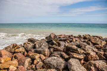Fototapeta na wymiar Rocks in front of the sea. Beach of rocks and the sea in Vera Playa, Andalusia, Spain
