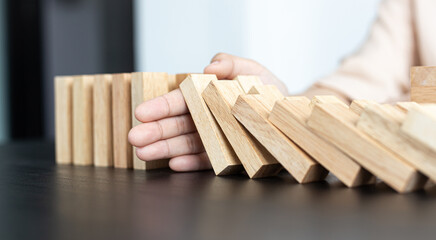 White Asian Woman Stopping Dominoes Fall In the office.