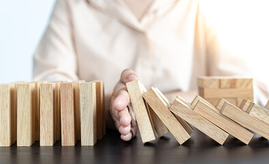 White Asian Woman Stopping Dominoes Fall In the office.