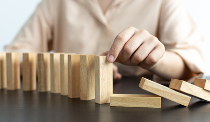 White Asian Woman Stopping Dominoes Fall In the office.