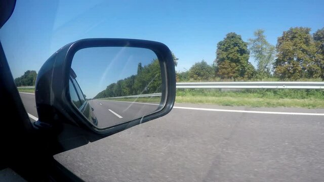 4K Rear window view from car going by highway at great speed. Transportation, personal cars concept.